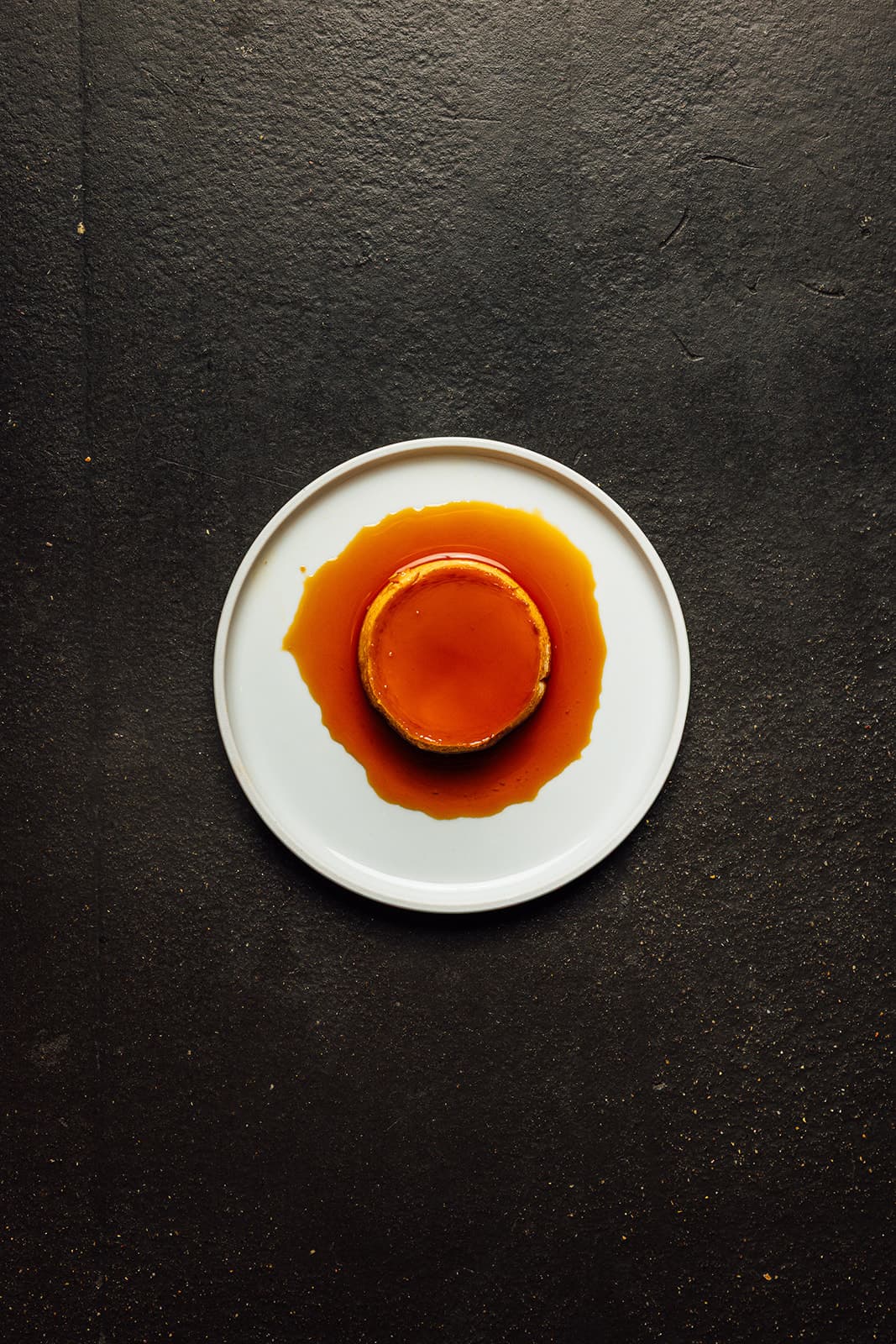 Leche flan on a dark table