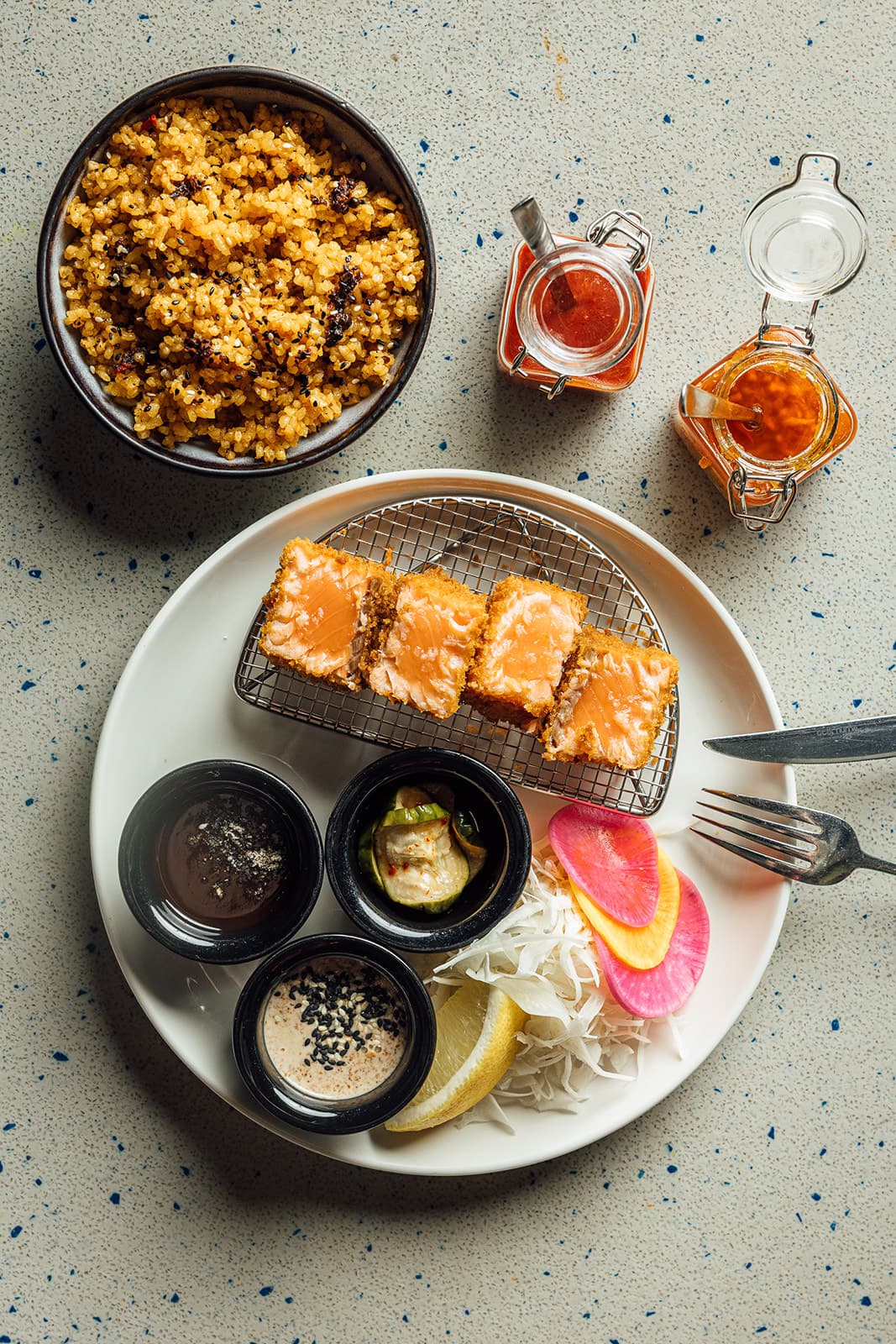 Salmon katsu with sauces and garlic bulgur